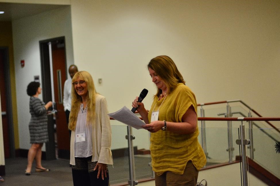 CPED Executive Director Jill Perry presenting the Imig Award to Debby Zambo