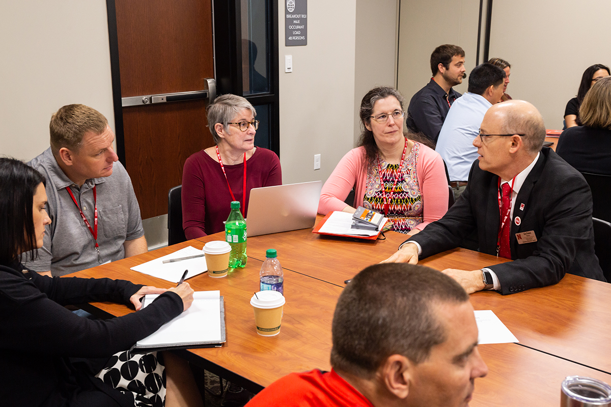 Members talking at a convening table